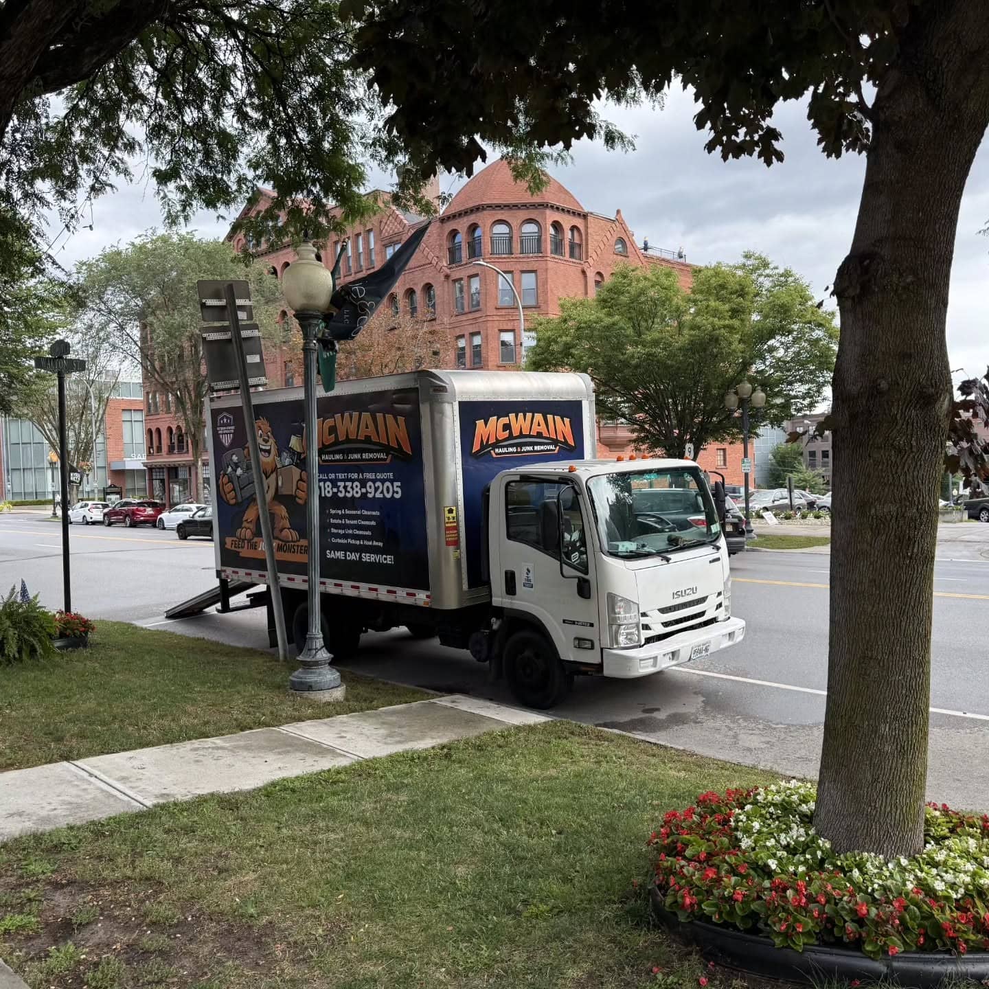 McWain Hauling box truck with the Junk Monster wrap parked on Broadway in downtown Saratoga Springs