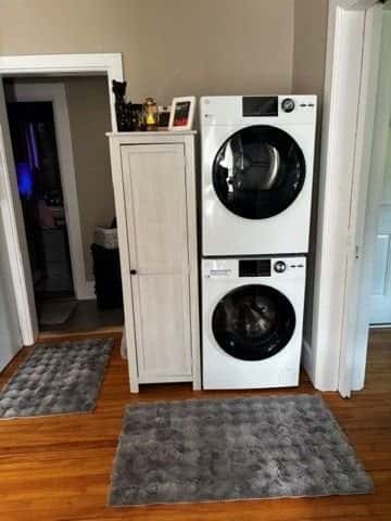 Stacked white washer and dryer installed next to a tall cabinet, customer's photo